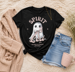 Spirit Led Blushing Ghost Tee styled with denim shorts, blush cardigan, jewelry, and pink mug