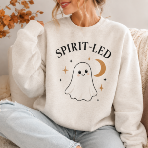 Woman wearing the Spirit-Led Halloween crewneck with ghost and crescent moon design