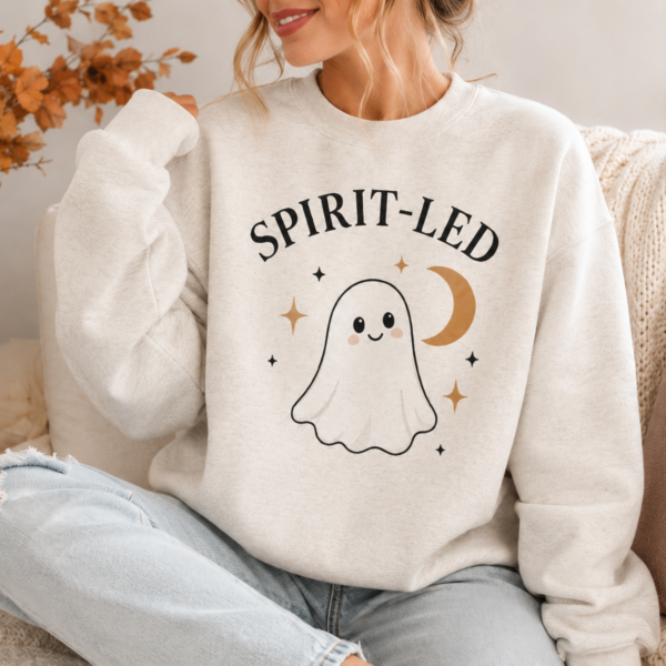 Woman wearing the Spirit-Led Halloween crewneck with ghost and crescent moon design