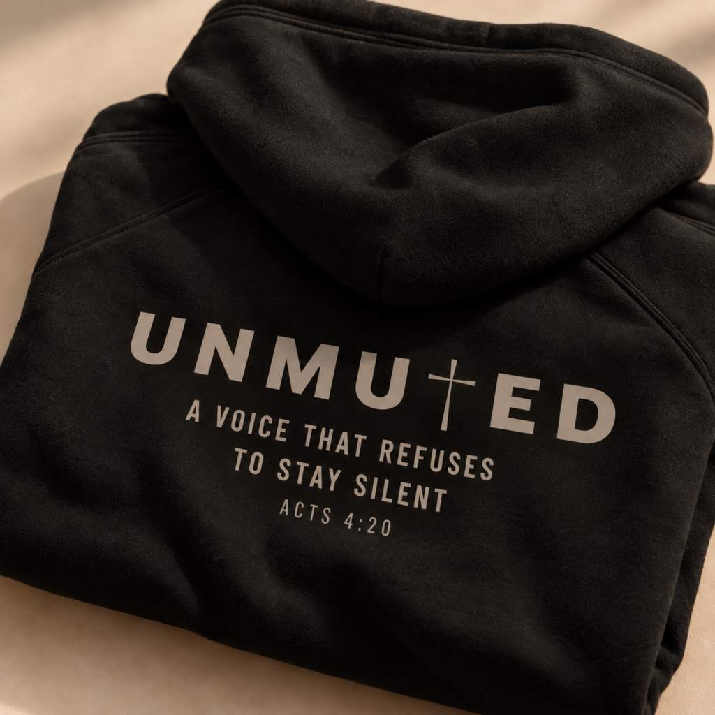 Black UNMUTED hoodie featuring Acts 4:20 and A Voice That Refuses to Stay Silent.